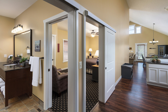 Inside view of the honeymoon cottage with bedroom, bathroom, and kitchen partial views